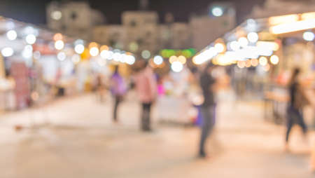 image of blurred background night market on street decorated with festive lights.の写真素材