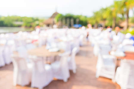 blur image of Tables and decoration prepared for an outdoor party for background usage.の写真素材