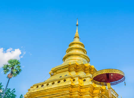 image of old temple with white cloud and blue sky at Wat Prathat Jomthong,Chiang Mai Thailand,traditional golden pagodaの写真素材