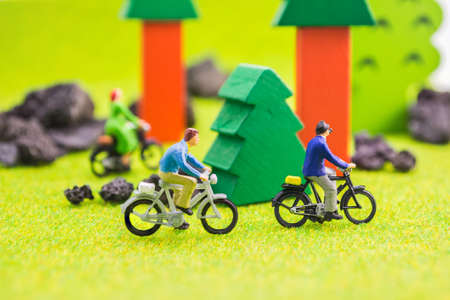 image group of people(mini figure dolls) with retro bicycle in a park.の写真素材
