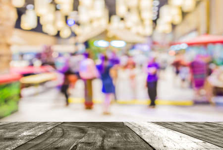Blurred image of people walking at shopping mall , blur background with bokeh .