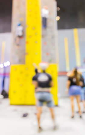 blurred image of people climbing wall , blur background with bokeh .の写真素材