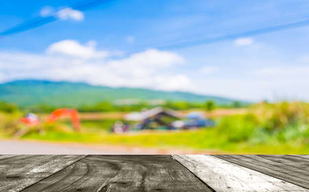 blur image of orange excavator doing lake construction and maintenance services under municipality authority on day time for background usage.の写真素材