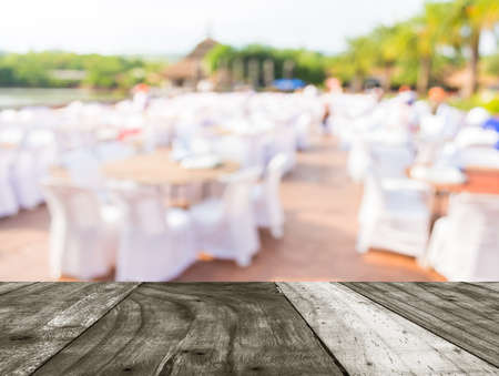 blur image of Tables and decoration prepared for an outdoor party for background usage.の写真素材