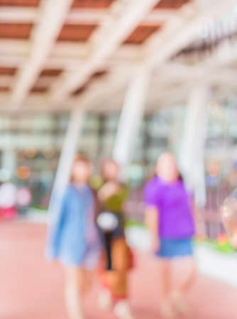 blur image of people walking at corridor with open space to the green garden for background usage.の写真素材