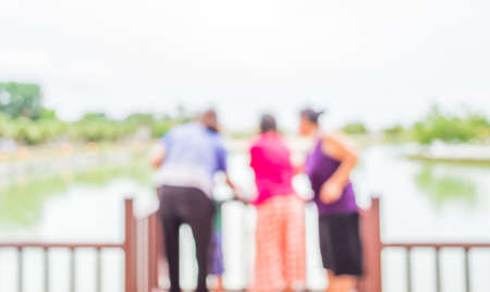 blur image of people on lakeside with bokeh for background usage.の写真素材