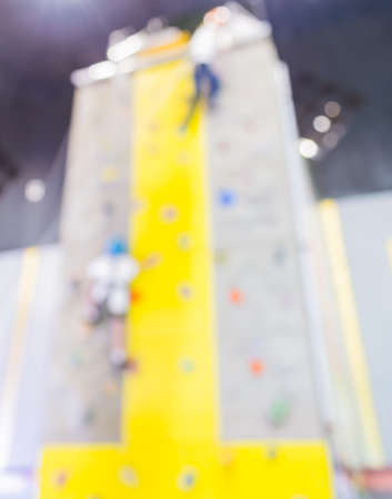 blurred image of people climbing wall , blur background with bokeh .の写真素材