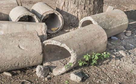 image of Old and cracked concrete pipe for watering.の写真素材