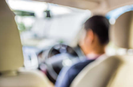 blurred image of people driving car on day time for background usage .の写真素材