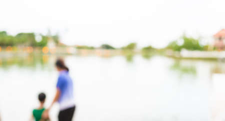 blur image of people on lakeside with bokeh for background usage.の写真素材