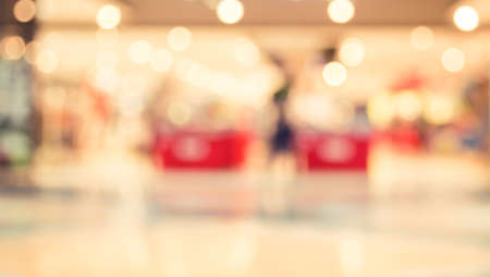 blurred image of modern shopping mall and people with bokehの写真素材