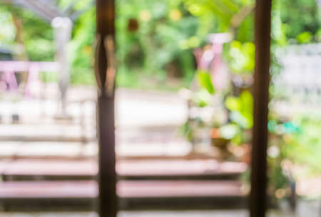 image of blur window and garden with bokeh for background usage.