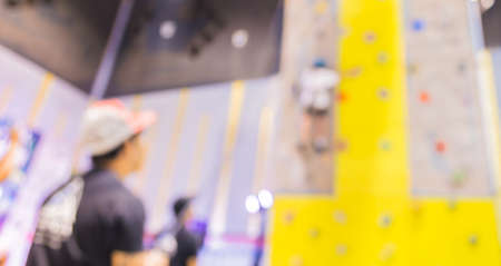blurred image of people climbing wall , blur background with bokeh .の写真素材