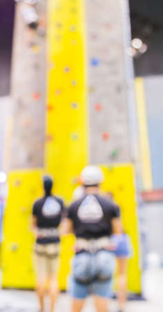 blurred image of people climbing wall , blur background with bokeh .の写真素材