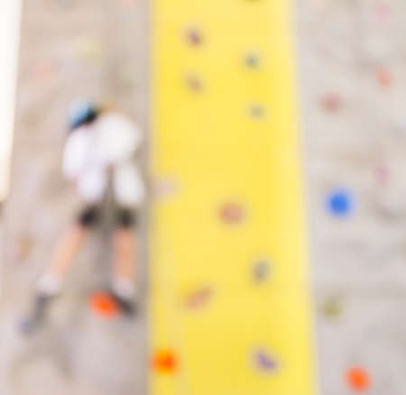 blurred image of people climbing wall , blur background with bokeh .の写真素材
