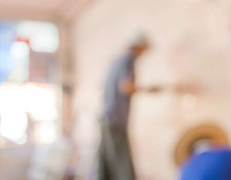 blur image of people  fixing house wall for background usage.の写真素材