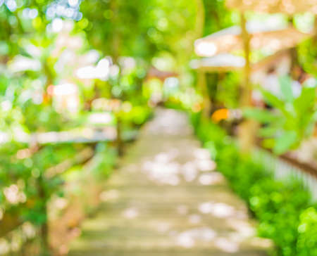 blur image of Long empty corridor with open space to the green garden with bokeh for background usage .の写真素材