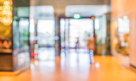 blurred image of shopping mall and people for background usage .