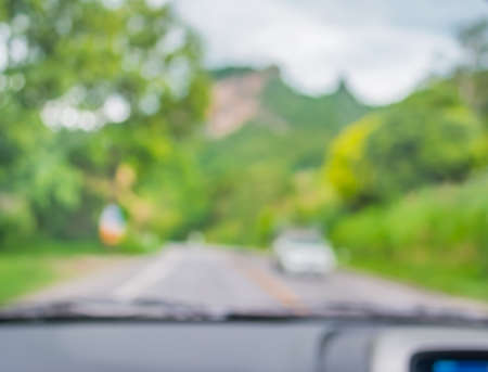 blur image of inside cars to see the road  with bokeh lights for background usage.の写真素材