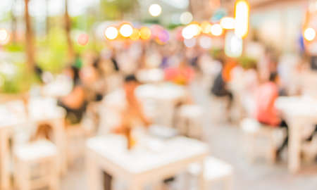 blur image of people sit on the table with festival bokeh lights on day time for background usage.の写真素材
