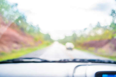 blur image of inside cars to see the road  with bokeh lights for background usage.の写真素材