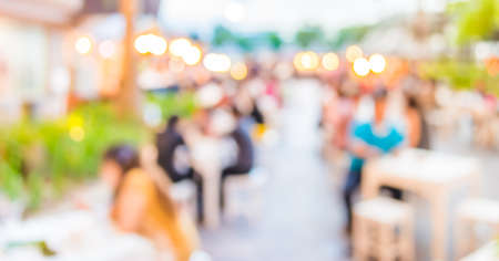 blur image of people dinner at outdoor festival   in park , background with bokeh .の写真素材