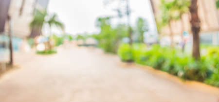 blur image of Long empty corridor with open space to the green garden with bokeh for background usage .の写真素材