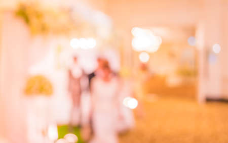 blurred image of Large dining table set for wedding, dinner or festival event with beautiful lights...