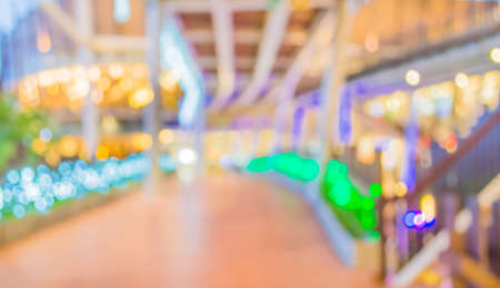 blur image of Long empty corridor on night time with bokeh for background usage.の写真素材