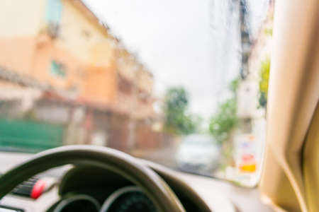 blur image of inside cars with bokeh during raining on day time.