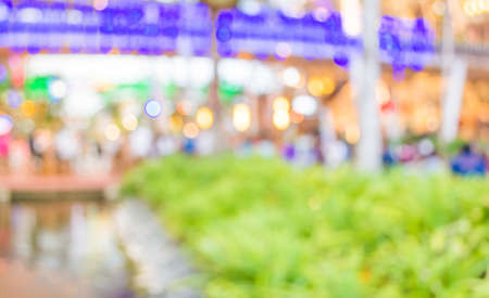 blur image of people sit on the table with festival bokeh lights on day time for background usage.の写真素材
