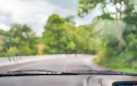 blur image of inside cars to see the road  with bokeh lights for background usage.の写真素材