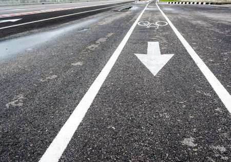 image of asphalt road and new bike lane with sign for background usage.の写真素材