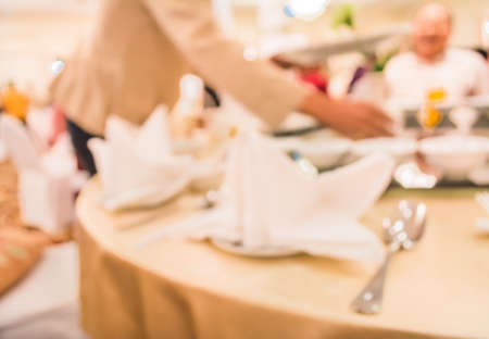 image of blur people on dinning table set for background usage .の写真素材