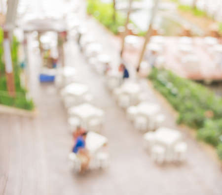 blur image of Tables and decoration prepared for an outdoor party for background usage.の写真素材