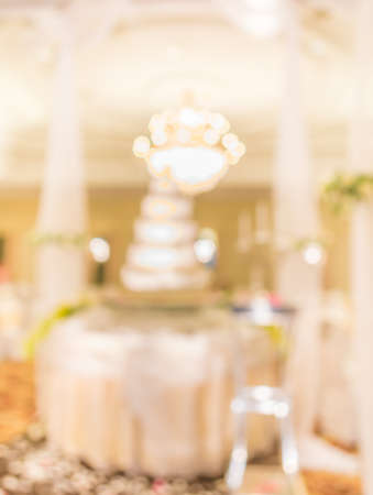 blur image of wedding cake  in large hall for background usage.の写真素材