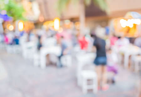 blur image of people sit on the table with festival bokeh lights on day time for background usage.の写真素材