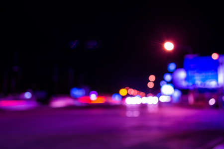 image of blur street  bokeh  with purple tone lights in night time for background usage .の写真素材