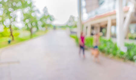 blur image of people wagging dog at open space to the green garden   for background usage .の写真素材