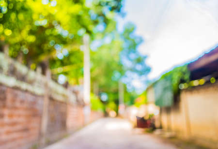 blur image of Long empty corridor with open space to the green garden with bokeh for background usage.の写真素材