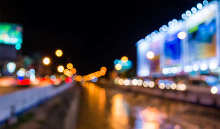image of blur street and canel  bokeh  in night time with warm colorful lights for background usage...