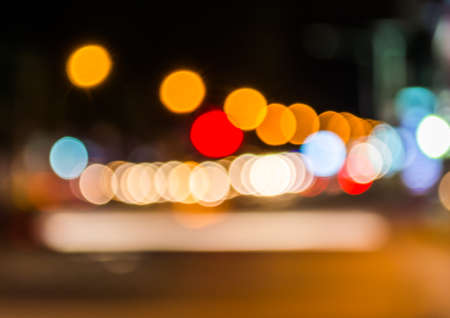image of blur street  bokeh  with warm colorful lights in night time for background usage .の写真素材