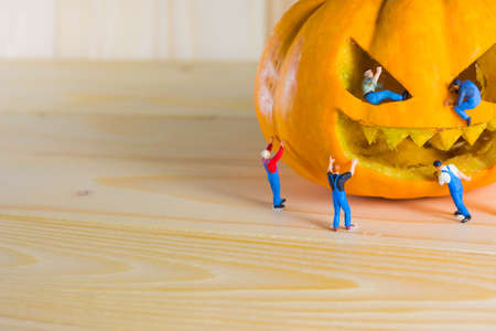 vintage color tone image of doll and pumpkin for halloween background.の写真素材