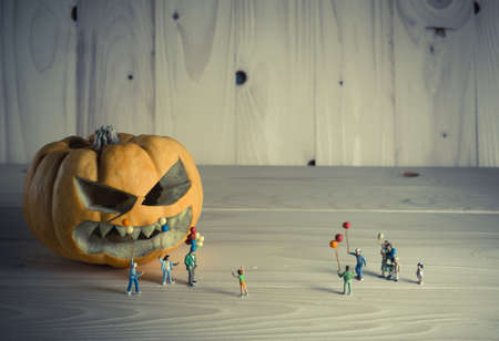 vintage color tone image of doll and pumpkin for halloween background.の写真素材