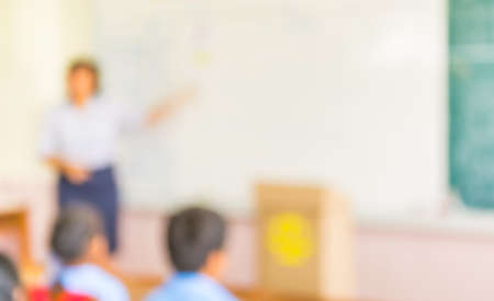 blur kids and teacher in the classroom for background usage.の写真素材