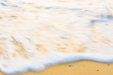 blur image of sea shore and yellow sand  for background usage(yellow tone)の写真素材