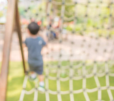 Defocused and blur image of children's playground at public park for background usage.の写真素材