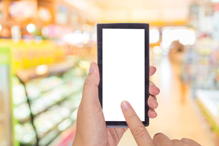male hand is holding a modern touch screen phone and image of food store blur  with bokeh for...