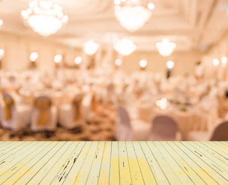 blurred image of Large dining table set for wedding, dinner or festival event with beautiful lights...