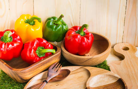 image of sweet peppers on wooden table background.